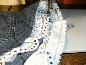 Attach the trim & stitch down, leaving 1cm denim clear on the bottom outside edge