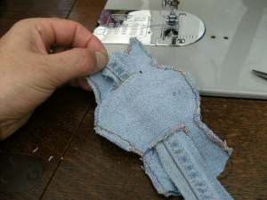 Zigzag front & back together, leaving a hole for stuffing, and insert tie through back slits