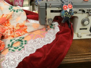 Stitching the patchwork & lace onto the velvet...